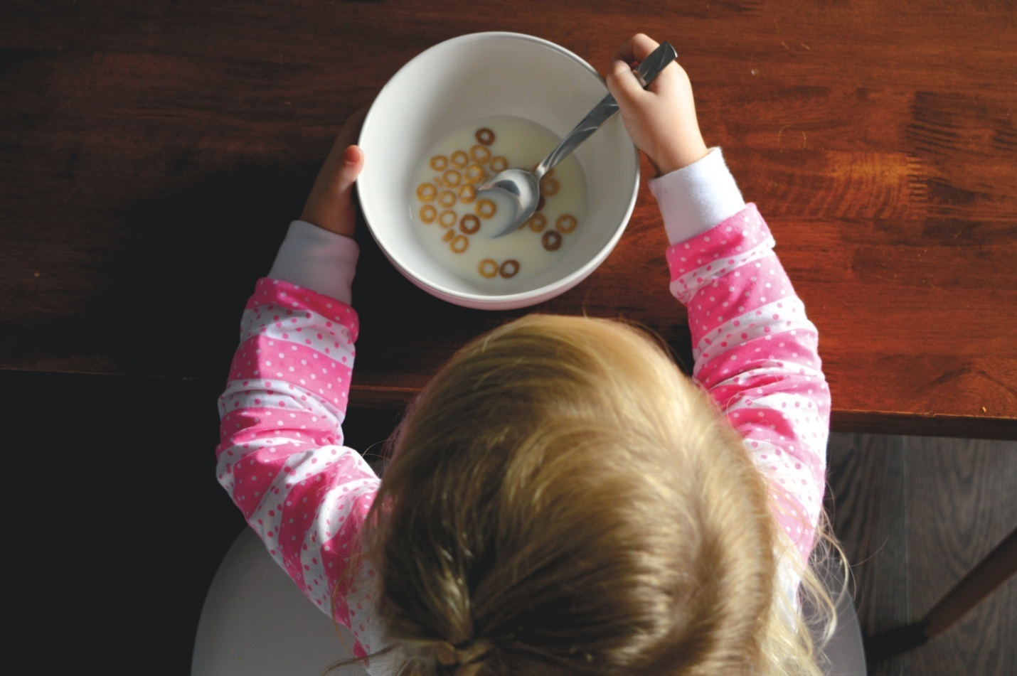 A kid eating a bowl of cereal